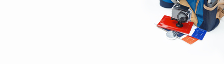 Time to Travel. Idea for tourism with action camera, plane tickets with a passport and compass. Concept on white background and backpack with portable charging.の写真素材