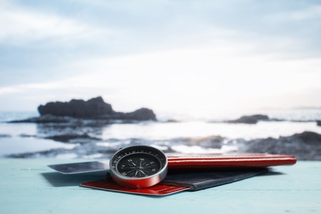 Time to Travel. Idea for tourism with passport, tickets and compass on the background of the beach and palm. Concept on the theme of flightsの写真素材