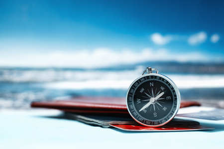Time to Travel. Idea for tourism with passport, tickets and compass on the background of the sea. Concept on the theme of flightsの写真素材