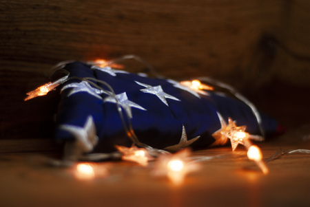American flag with Garland on a wooden background for Memorial Day and other holidays of the United States of Americaの写真素材