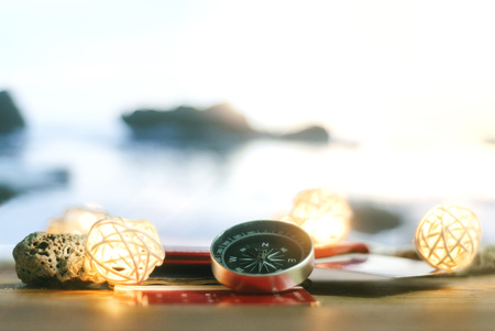Time to Travel. Idea for tourism with passport, tickets and compass with garlands on the background of the sea. Concept on the theme of flightsの写真素材