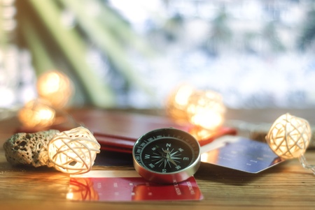 Time to Travel. Idea for tourism with passport, tickets and compass with garlands on the background palm. Concept on the theme of flightsの写真素材