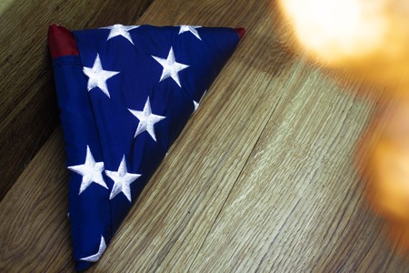 American flag with Garland on a wooden background for Memorial Day and other holidays of the United States of Americaの写真素材
