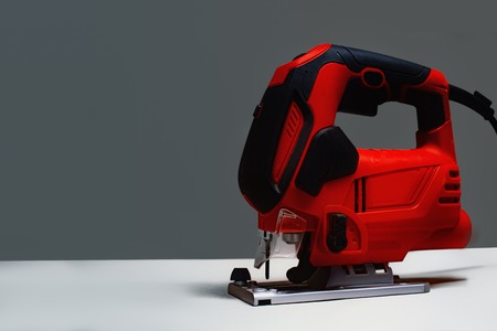 Electric jig saw machine on the background gray wall.の写真素材