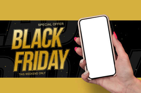 Woman Hand holding the black Mockup smartphone with beautiful nails on the background Black Friday. Mobile device isolated on blue colourの写真素材