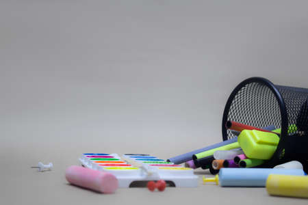 Paints for painting and stationery in the basket. Back to school backgroundの写真素材