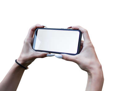 Woman Hand holding the black Mockup smartphone with isolated screen and beautiful nails. Mock-up...