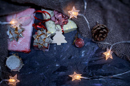 Christmas and New Year background. Gifts in a box with decoration with ribbons and bows with burlap...