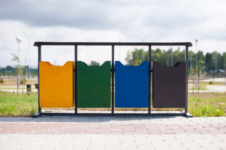 Ecological trash cans in different colors in the open air park. Distribution of household wasteの写真素材