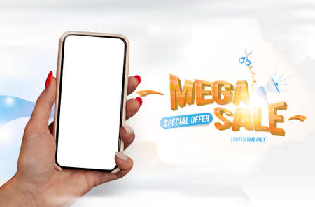 Mega Sale concept. A girl with beautiful nails holds a mock-up of a smartphone with a white screen on a light backgroundの写真素材