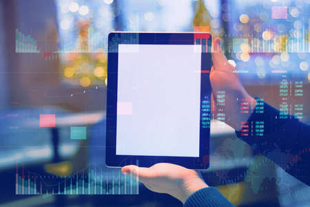 Business analytics (BA) with key performance indicators (KPI) dashboard concept. Tablet mockup with white screen. Businessman works at the computerの写真素材