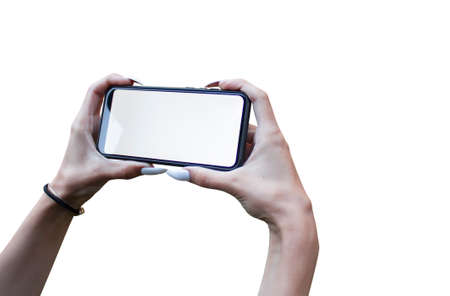 Woman Hand holding the black Mockup smartphone with isolated screen and beautiful nails. Mock-up Technologyの写真素材