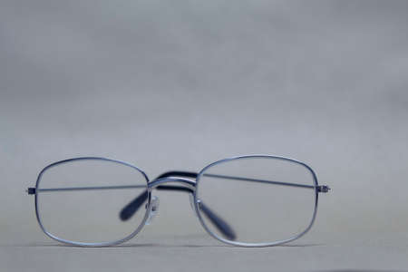 Glasses for sight with clear glass lie on a neutral backgroundの写真素材