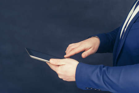 Businessman in a shirt and a blue jacket with Tablet in hand