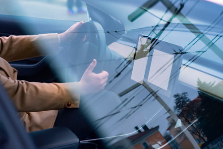 A male driver is driving a modern car. Automobile interior photography