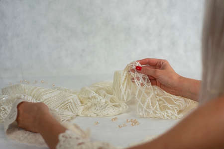 Light satin fabric with beadsの写真素材