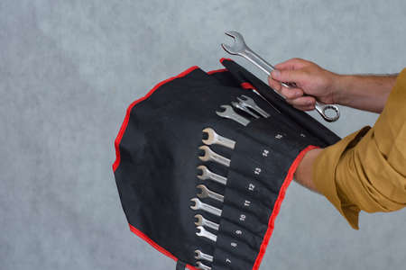 Man holds a set keys for car repairの写真素材