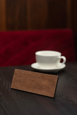 A white cup on a wooden table in a restaurantの写真素材