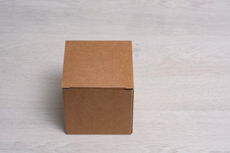 Eco friendly packaging sustainable shipping box on light background. Simple and sturdy packaging for product protectionの写真素材