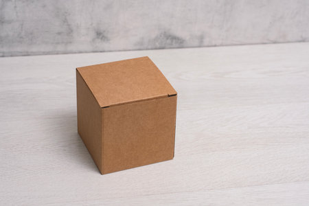 Eco friendly packaging sustainable shipping box on light background. Simple and sturdy packaging for product protectionの写真素材