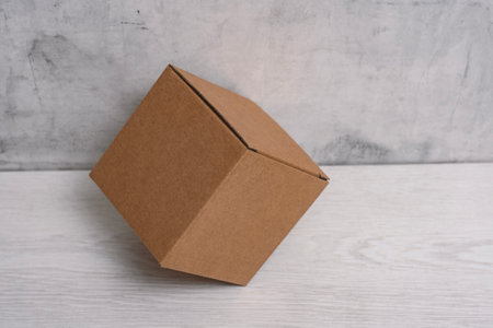 Eco friendly packaging sustainable shipping box on light background. Simple and sturdy packaging for product protectionの写真素材