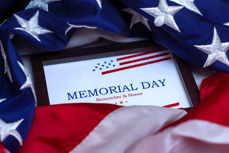 Patriotic message for Memorial Day USA in a wooden frame on a American flag backgroundの写真素材