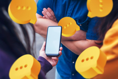 Close-up image of a hand holding a smartphone with blank screen surrounded by yellow speech bubble...