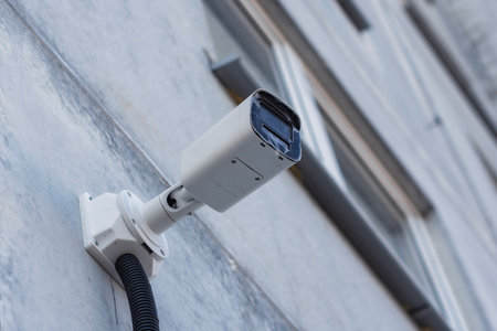 CCTV camera on the wall of a residential building for surveillance and protection in an urban area