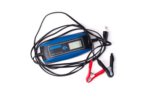 Smart charger for automotive use, insulated on white background. Tool for repair, car maintenance and battery chargingの写真素材
