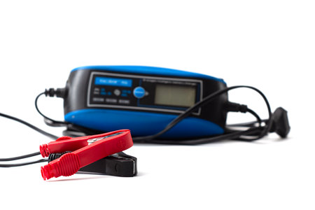 Smart charger for automotive use, insulated on white background. Tool for repair, car maintenance and battery chargingの写真素材