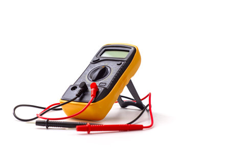 Digital multimeter close-up with test probes isolated on white background. Tool for diagnostics of electronics and voltage measurementの写真素材