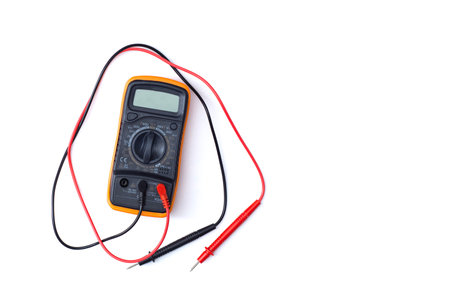 Digital multimeter close-up with test probes isolated on white background. Tool for diagnostics of electronics and voltage measurementの写真素材