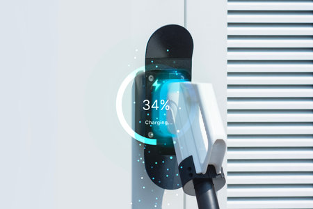 Close-up electric vehicle charging station with a futuristic digital interface showing the charging progress. Concept sustainable transportation, clean energy and infrastructure for electric vehiclesの写真素材
