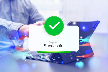 Notification of a successful online payment. A person is holding a credit card while making an online transaction through a tablet. Concept for e-commerce and online transactionsの写真素材