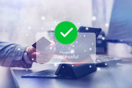 Notification of a successful online payment. A person is holding a credit card while making an online transaction through a tablet. Concept for e-commerce and online transactionsの写真素材