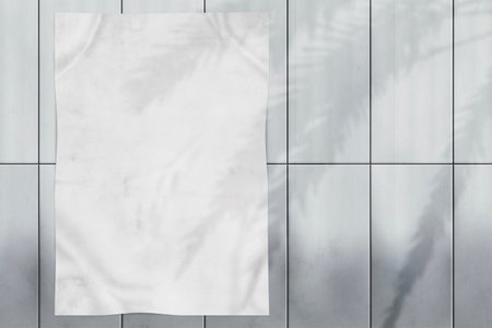 Realistic Mockup of a crumpled white poster hanging on a light colored metal wall. Poster to showcase design, advertising or wearable artworkの写真素材