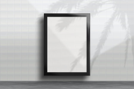 Mockup of a vertical black poster hanging on a white ceramic tile wall. Poster for showcasing design, art or advertisingの写真素材