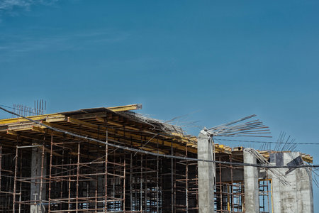 Dangerous collapse of concrete formwork on a construction site. Broken supports, bent rebar, and exposed concrete columns. Concept construction site safety and engineering mistakes workplaceの写真素材