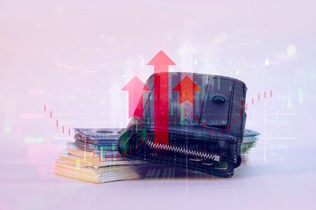 A black wallet on a stacks US dollar bills. Red upward-pointing arrows and financial bar graphs, symbolizing growth and success. Concept financial prosperity and economic growthの写真素材
