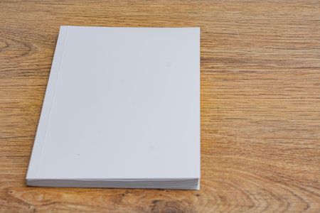 Realistic mockup of book cover, magazine on the wooden background. Concept for demonstrating editorial design, book covers and printed materialsの写真素材