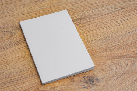 Realistic mockup of book cover, magazine on the wooden background. Concept for demonstrating editorial design, book covers and printed materialsの写真素材