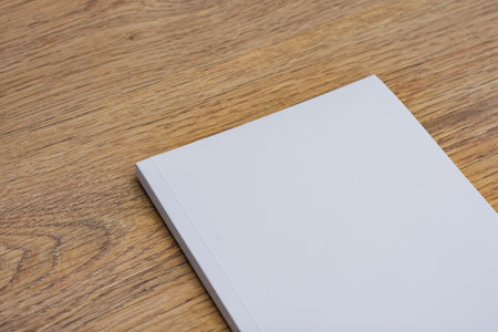 Realistic mockup of book cover, magazine on the wooden background. Concept for demonstrating editorial design, book covers and printed materialsの写真素材