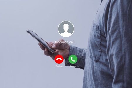 Notification of an incoming call on a smartphone held by a man wearing a shirt. Concept of mobile...