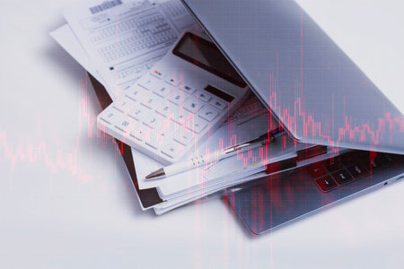 Business tools, laptop with calculator and documents with red graph and downward trend. Concept of...