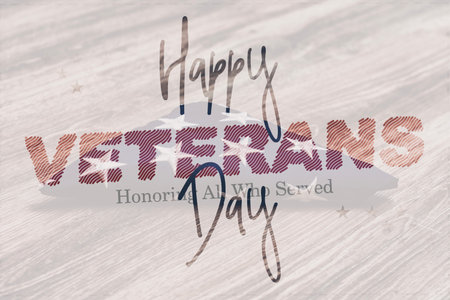 Patriotic Veterans Day greeting with the text Happy Veterans Day Honoring All Who Served over the folded United States flag on a wooden surface. Concept of American patriotismの写真素材