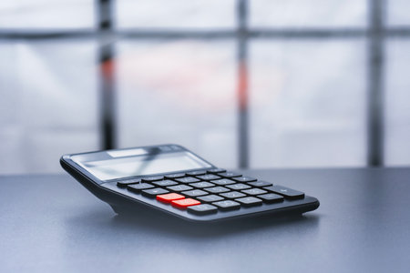 Black calculator in modern corporate office bank. Concept financial management, accounting and professional planningの写真素材