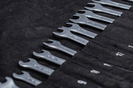 Collection of chrome-plated metal wrenches. Professional hand tools for automotive repair,...