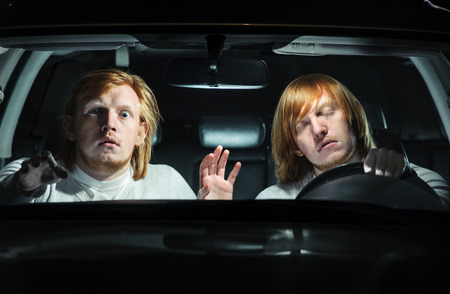 Man falling asleep behind the steering wheel, while his  twin is terrified, trying to warn him of an...