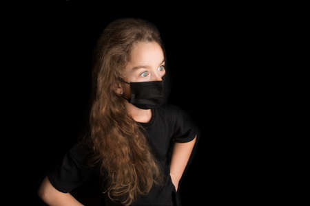 Funny girl wear stylish protective face mask due  pandemic. Family lifestyle on summer school holidays.の写真素材