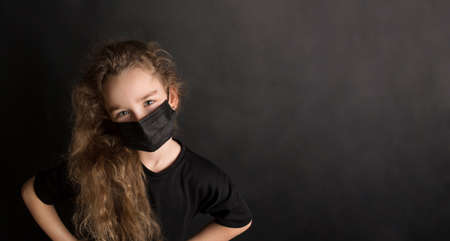 Funny girl wear stylish protective face mask due  pandemic. Family lifestyle on summer school holidays.の写真素材